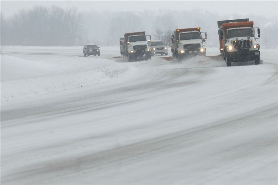 Snow plows clearing a highway